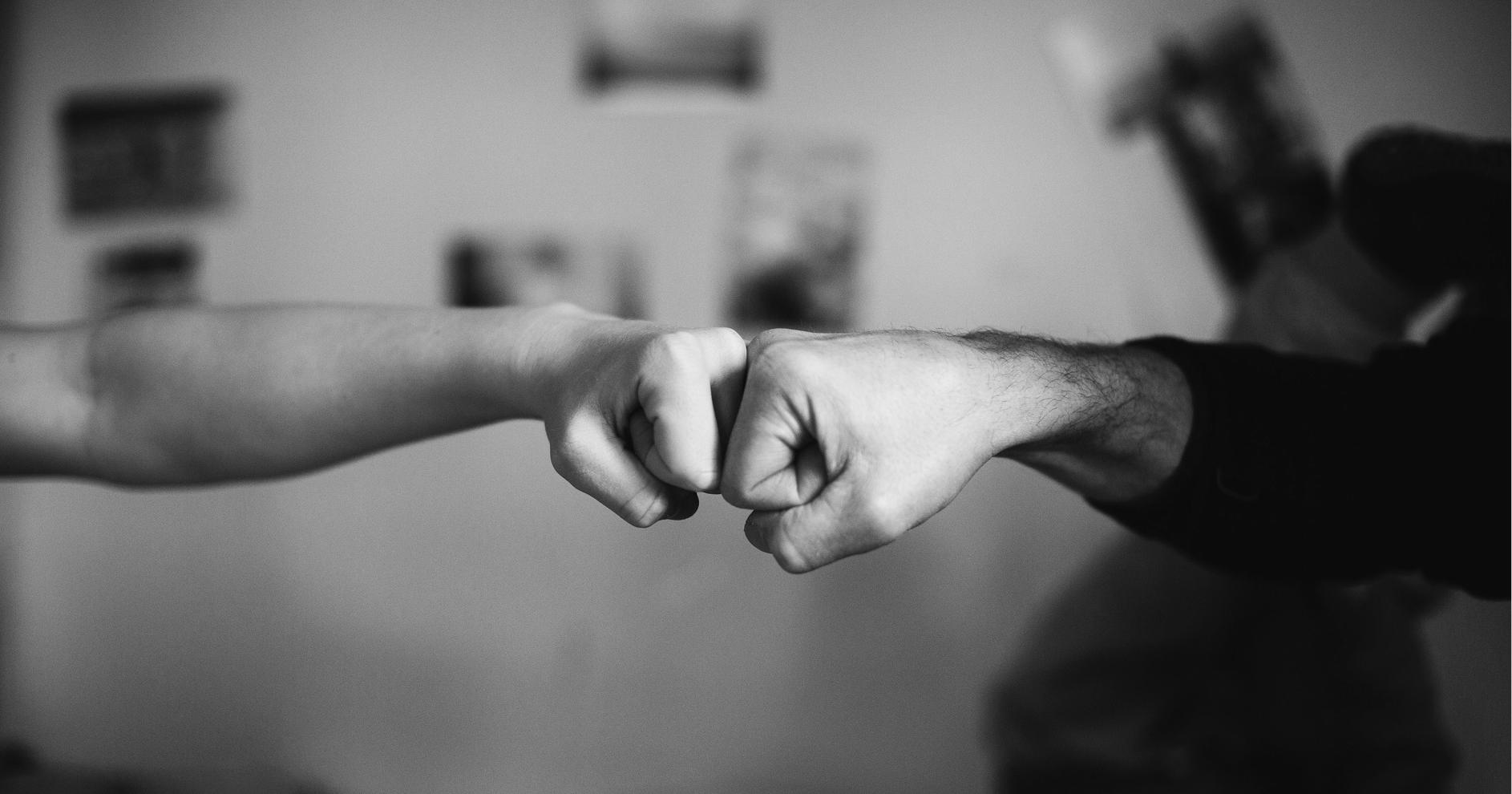 Man fist-bumping a child