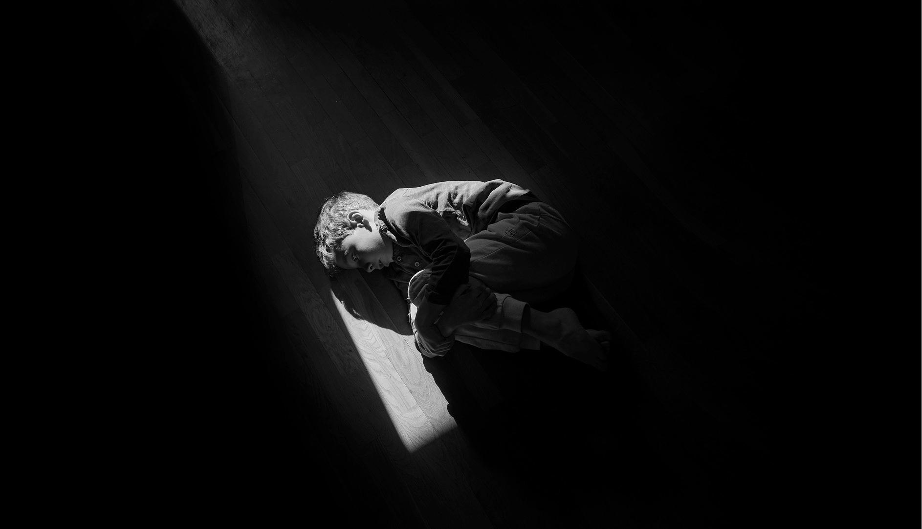 Boy lying on the floor feeling existential dread